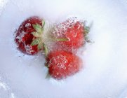 Frozen strawberries with stalks — Stock Photo