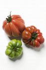 Red and green beefsteak tomatoes — Stock Photo