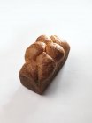Closeup view of one Brioche bun on white surface — Stock Photo