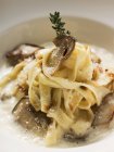 Tagliatelle pasta with ceps and sauce — Stock Photo
