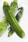 Green courgettes in water — Stock Photo
