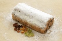 Stollen with icing sugar and ingredients — Stock Photo