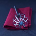 Closeup view of a one whisk on a red towel — Stock Photo