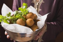 Woman serving falafel chickpea balls — Stock Photo