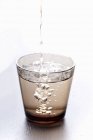 Pouring water into glass — Stock Photo
