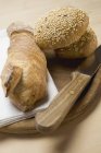 Baguette and wholemeal bread rolls — Stock Photo