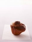 Closeup view of one Brioche on piece of paper — Stock Photo