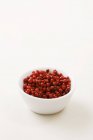 Pink peppercorns in small bowl — Stock Photo
