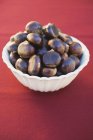 Chestnuts in white bowl — Stock Photo