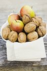 Walnuts on cloth in bowl — Stock Photo