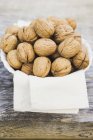 Walnuts on cloth in bowl — Stock Photo