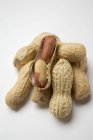 Several peanuts on white — Stock Photo