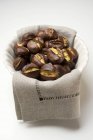 Roasted chestnuts on cloth — Stock Photo