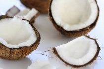 Opened coconuts on white — Stock Photo