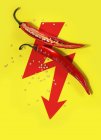A sliced-open chilli pepper on a red arrow — Stock Photo