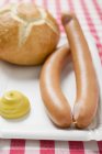 Frankfurters with mustard and bread roll — Stock Photo