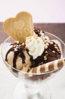 Closeup view of chocolate and nut Sundae with cream and wafers — Stock Photo