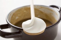 Wooden spoonful of creme frache — Stock Photo