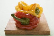 Grilled peppers on chopping board — Stock Photo