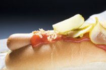 Hot dog with ketchup and gherkins — Stock Photo