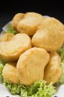 Closeup view of chicken nuggets on lettuce leaves — Stock Photo