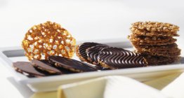 Closeup view of walnut Florentines with chocolate on plate — Stock Photo