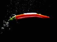 Red chilli pepper in water — Stock Photo