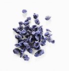 Closeup view of candied lilac flowers on white surface — Stock Photo