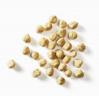 Caramelised hazelnuts on white — Stock Photo