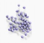 Closeup view of candied lavender flower balls on white surface — Stock Photo