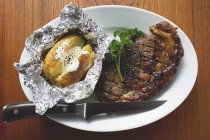 Grilled beef steak with baked potato — Stock Photo