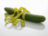 Cucumber with tape measure — Stock Photo