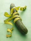 Cucumber with tape measure — Stock Photo