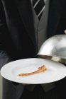 Butler serving rasher of fried bacon — Stock Photo