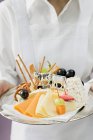 Waitress serving platter — Stock Photo