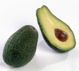 Whole and half avocado — Stock Photo