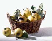 Quinces in small basket — Stock Photo