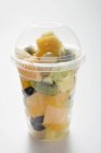Fruit salad in plastic beaker — Stock Photo