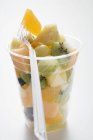Fruit salad in plastic beaker — Stock Photo