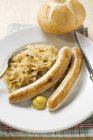 Sausages with sauerkraut and mustard — Stock Photo