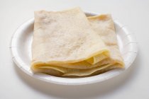 Closeup view of folded crepes on paper plate — Stock Photo