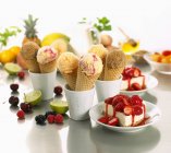 Waffle cones and fruits — Stock Photo