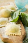 Homemade ravioli pasta with basil — Stock Photo