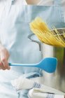 Женщина держит сковородку со спагетти — стоковое фото