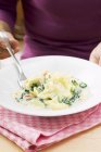 Woman with plate of tortellini pasta — Stock Photo