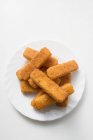Breaded fish fingers on plate — Stock Photo