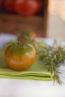 Green tomatoes on green napkin — Stock Photo