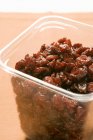 Dried cranberries in plastic container — Stock Photo