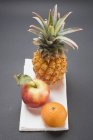 Pineapple with red apple — Stock Photo