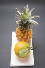 Pineapple and ripe orange — Stock Photo